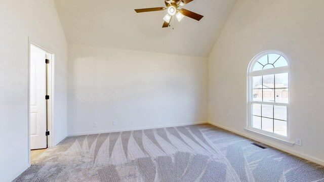 unfurnished room with visible vents, baseboards, carpet floors, high vaulted ceiling, and a ceiling fan