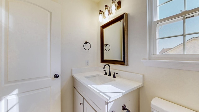 half bathroom featuring toilet and vanity