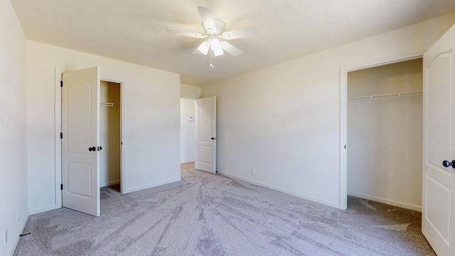 unfurnished bedroom with a closet, baseboards, a ceiling fan, and carpet flooring