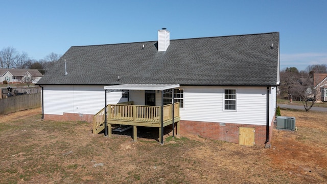 rear view of house featuring crawl space, central AC unit, a wooden deck, and a chimney