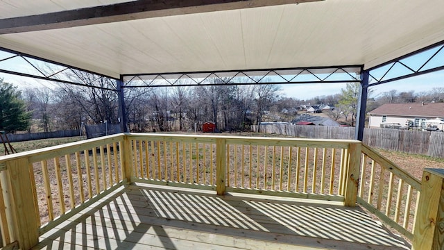 wooden terrace with a fenced backyard