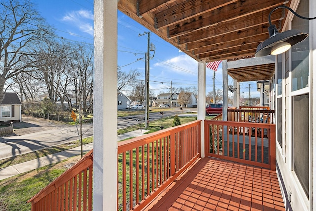 deck with a residential view and a porch