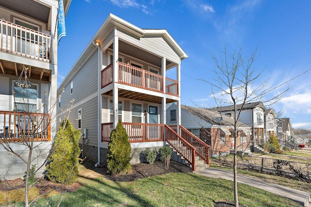 view of front of home with a porch and a front yard