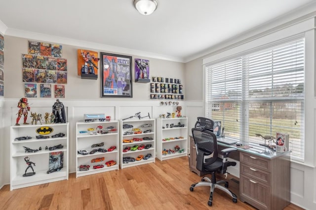 office featuring a wainscoted wall, crown molding, and wood finished floors