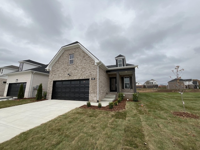 view of front of house featuring a front lawn, an attached garage, brick siding, and driveway