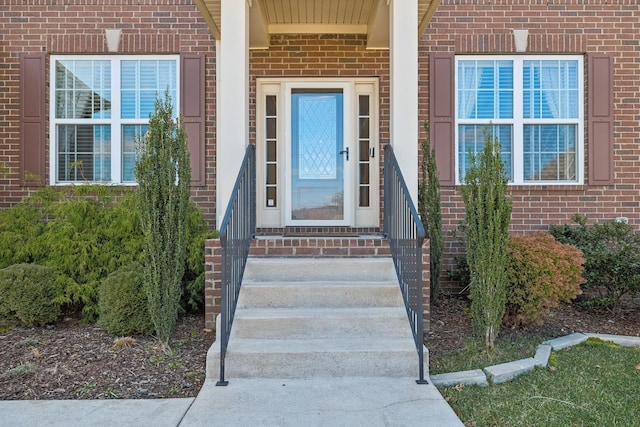 view of exterior entry with brick siding