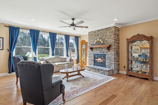 living room with a wealth of natural light, light wood finished floors, and ornamental molding