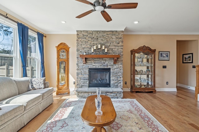 living area featuring a fireplace, wood finished floors, and ornamental molding