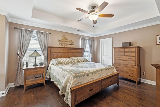 bedroom with baseboards, a raised ceiling, and dark wood-style floors