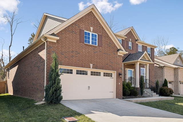 traditional-style home featuring a garage, brick siding, and driveway