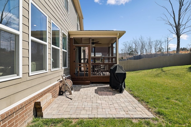 view of patio featuring grilling area, a deck, and fence