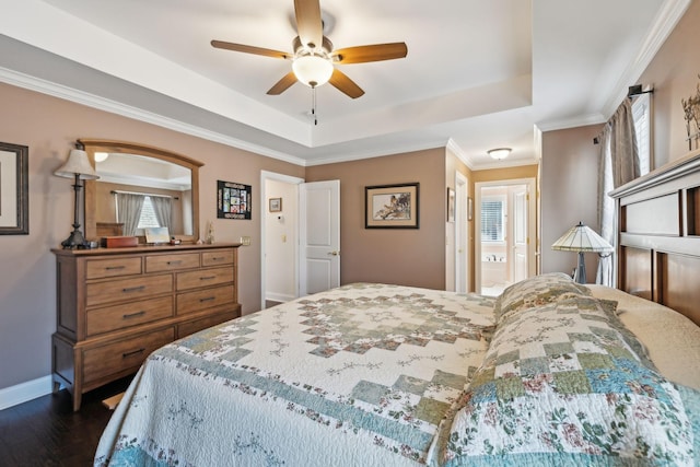 bedroom with a raised ceiling, dark wood-type flooring, ornamental molding, baseboards, and ceiling fan