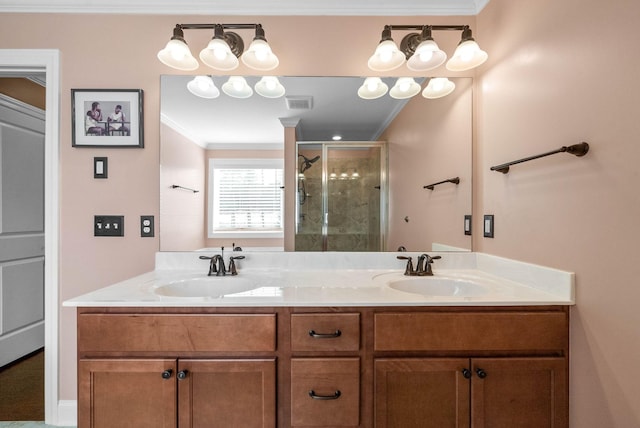 full bath with ornamental molding, visible vents, a stall shower, and a sink