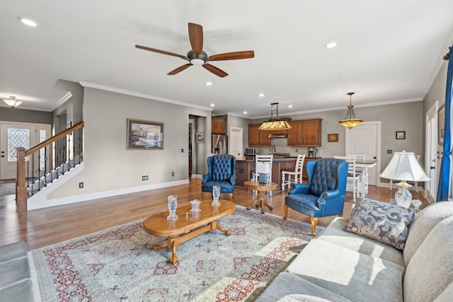 living area with wood finished floors, ceiling fan, recessed lighting, and baseboards