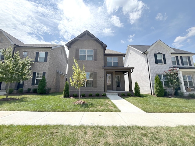 view of front of home featuring brick siding and a front lawn