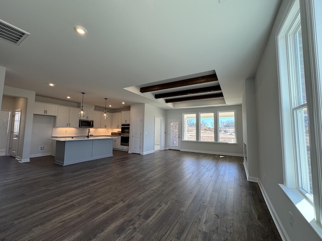 unfurnished living room with visible vents, baseboards, recessed lighting, dark wood-style flooring, and beamed ceiling