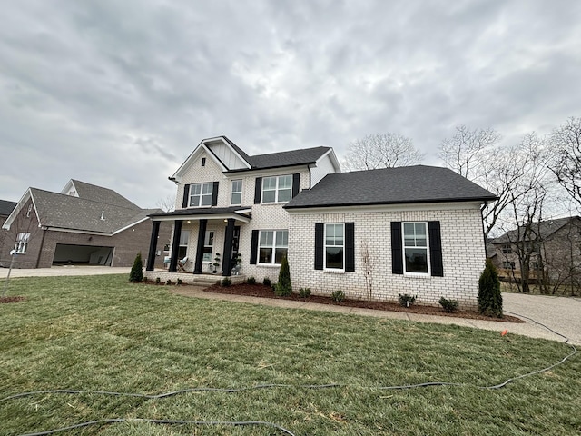 view of front of house featuring a garage, brick siding, concrete driveway, and a front lawn