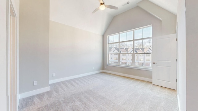 unfurnished room featuring visible vents, a ceiling fan, baseboards, light colored carpet, and vaulted ceiling