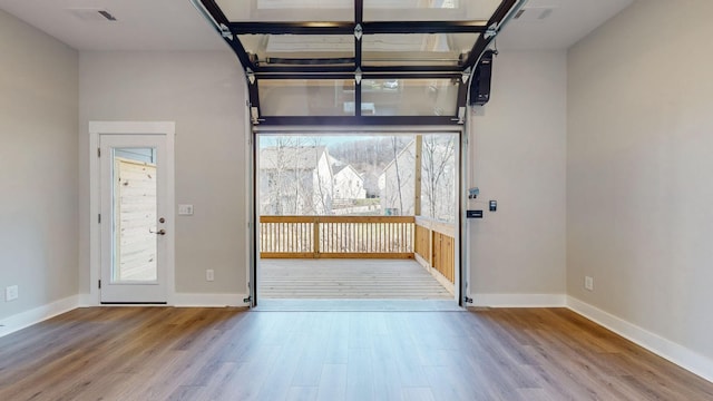 entryway featuring visible vents, baseboards, and wood finished floors