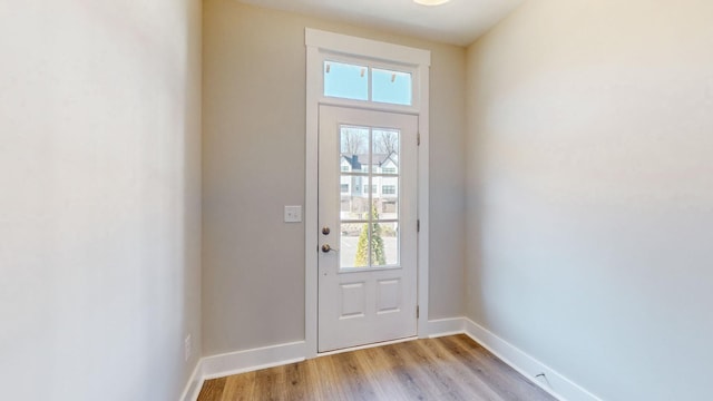 entryway featuring baseboards and light wood finished floors