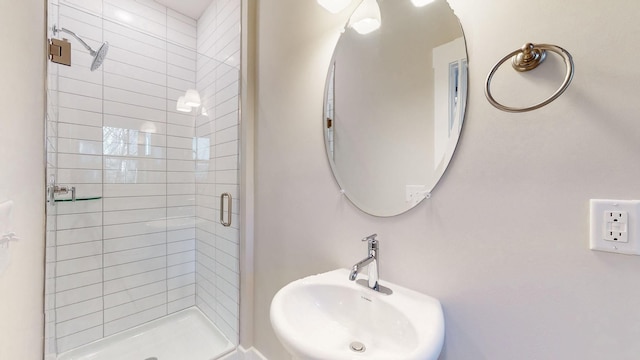 bathroom with a sink and a shower stall