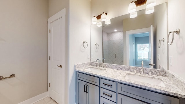 bathroom with a shower stall, double vanity, marble finish floor, and a sink