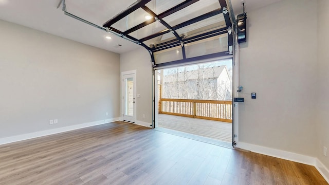 spare room featuring baseboards and wood finished floors