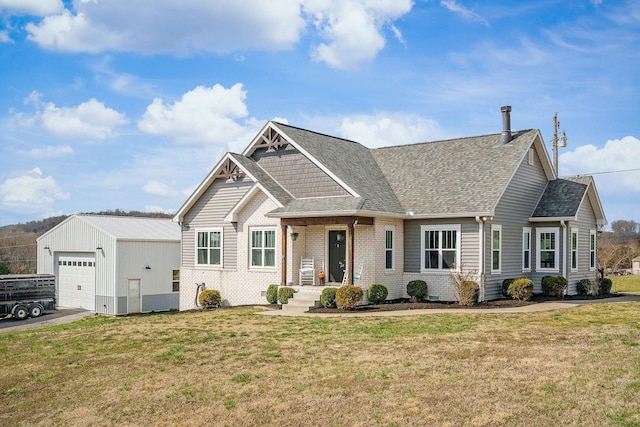 view of front of property featuring a front lawn, a garage, an outdoor structure, and roof with shingles