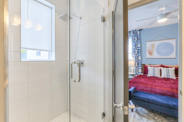 bathroom featuring a stall shower and a ceiling fan