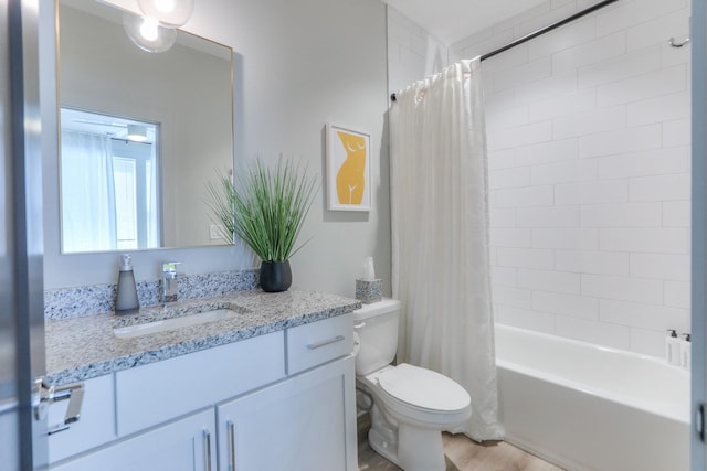 full bathroom featuring toilet, vanity, and shower / bathtub combination with curtain