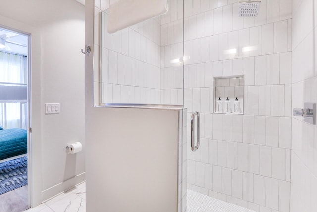 full bath featuring baseboards, marble finish floor, ensuite bathroom, and a tile shower