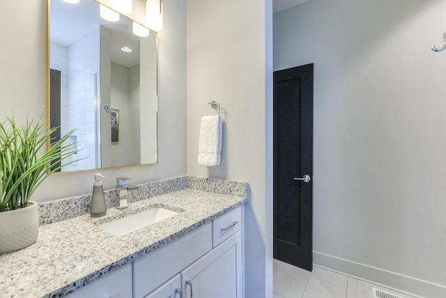 full bathroom featuring vanity, baseboards, and tile patterned flooring