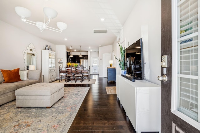 living area with a notable chandelier, recessed lighting, visible vents, and dark wood-style flooring