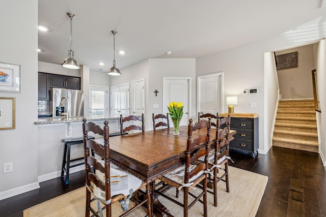 dining room with recessed lighting, baseboards, dark wood-style flooring, and stairs