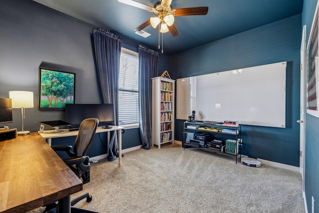 office area with carpet, baseboards, and ceiling fan