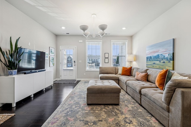 living room featuring recessed lighting, baseboards, dark wood-style flooring, and a chandelier