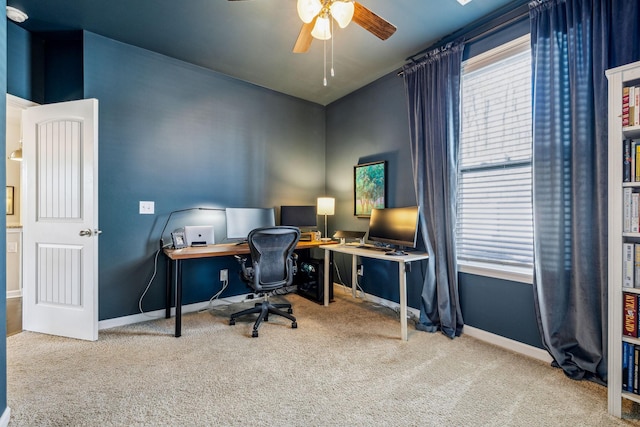 carpeted office with baseboards and ceiling fan