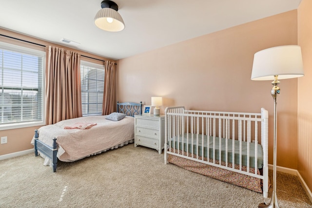 carpeted bedroom with visible vents and baseboards