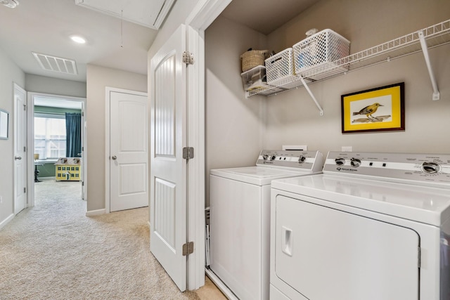 laundry room with visible vents, attic access, laundry area, light carpet, and washer and clothes dryer