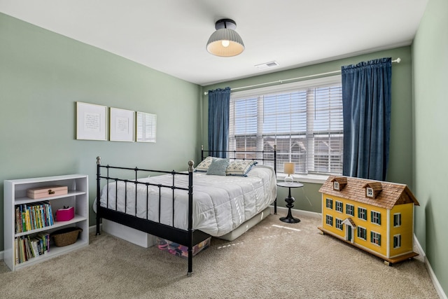 carpeted bedroom featuring visible vents and baseboards