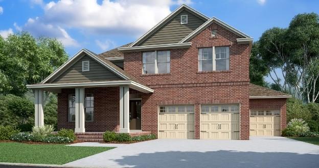 traditional home featuring brick siding, driveway, and a garage