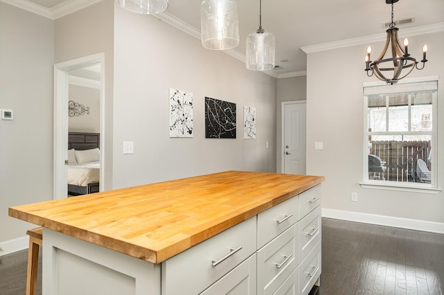 kitchen featuring baseboards, wooden counters, ornamental molding, dark wood-type flooring, and white cabinets