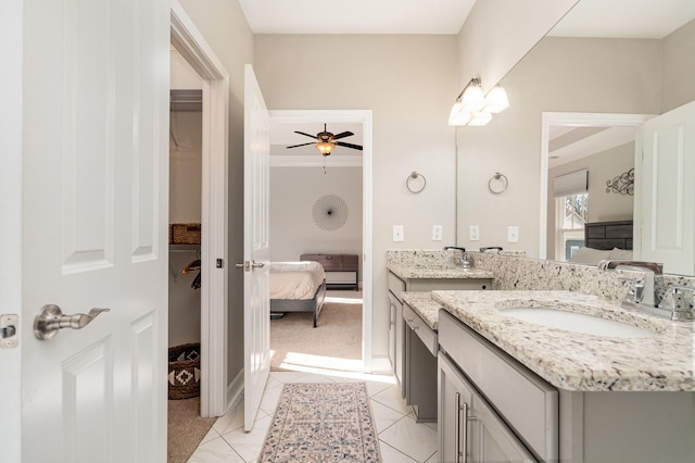 ensuite bathroom featuring a ceiling fan, vanity, ensuite bathroom, and tile patterned flooring