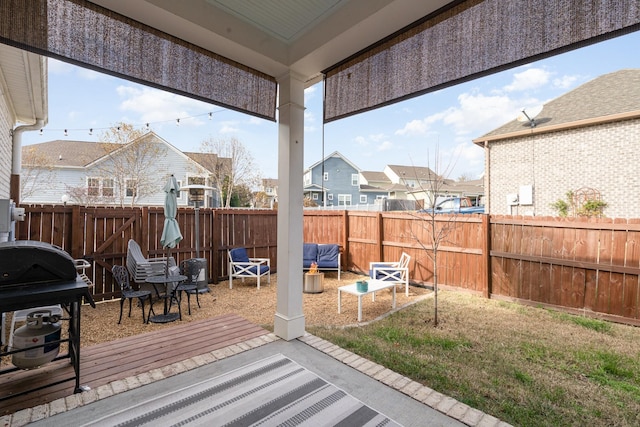 deck featuring grilling area, a residential view, and a fenced backyard