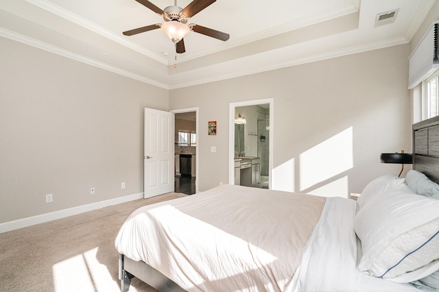 bedroom featuring baseboards, visible vents, crown molding, light carpet, and a raised ceiling