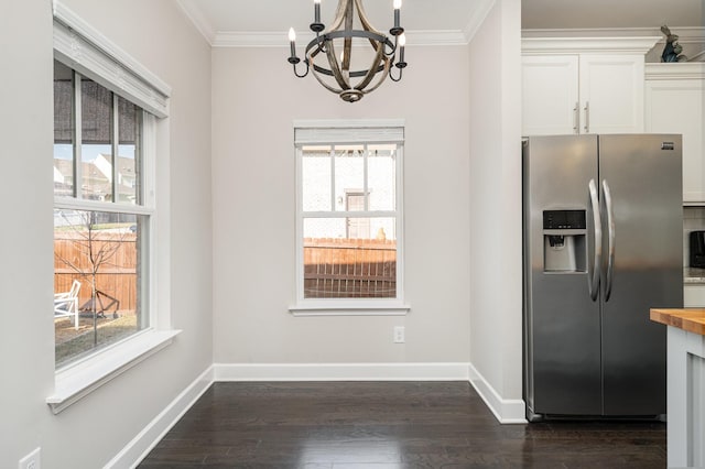 kitchen featuring white cabinetry, dark wood-type flooring, stainless steel fridge, and ornamental molding