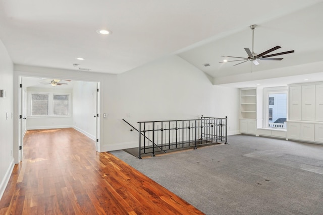 carpeted empty room featuring recessed lighting, baseboards, built in shelves, and vaulted ceiling