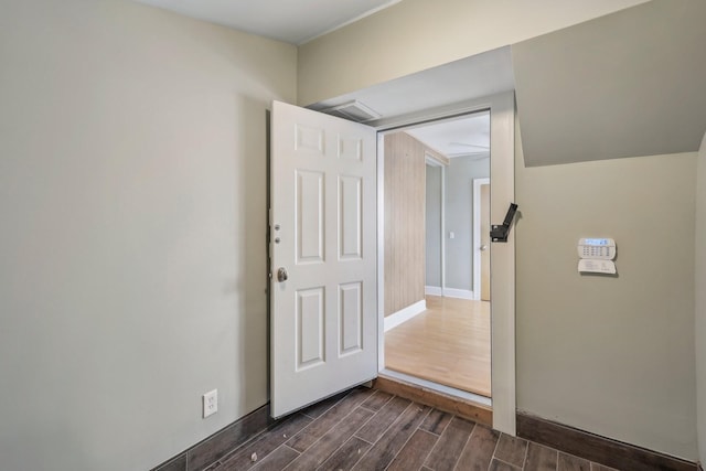 spare room featuring baseboards and wood tiled floor