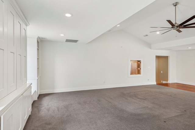 empty room featuring lofted ceiling, recessed lighting, baseboards, and visible vents