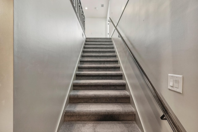 staircase featuring baseboards